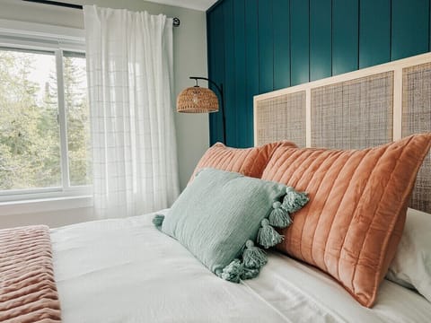 The colors in this bedroom are stunning and the lighting from the big rear-facing window offers such a peaceful space to retreat.