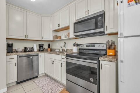 The kitchen features everything from like-new appliances to a crockpot, blender, and a spacious kitchen bar with 3 bar stools.