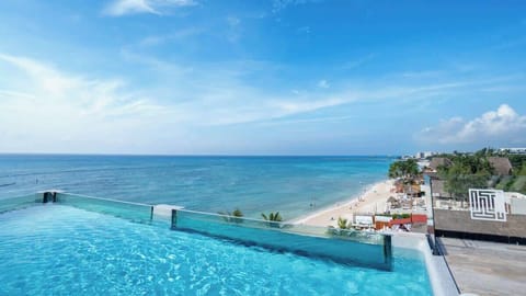 Rooftop infinity pool with direct views of the Caribbean.