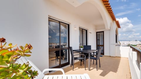 Sun-drenched private balcony with outdoor dining and a lounger, perfect for slow mornings or sunset drinks overlooking the neighborhood. #balcony #terracevibes #outdoorliving #algarvelife
