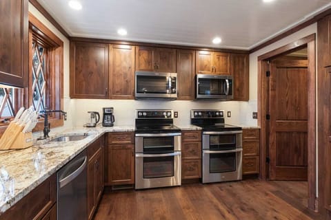 Kitchen is Equipped with Dual Ovens, Two Sinks, and Two Dishwashers