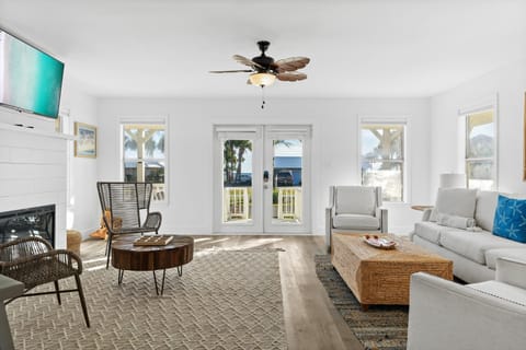 Living Room with comfortable seating, partial Gulf views, 55” Smart TV, and gas fireplace