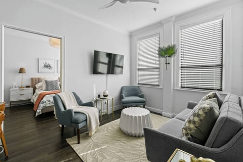 Living Area with AC surrounded by windows, enters natural sunlight. Smart Flatscreen TV
