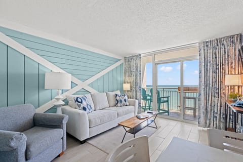 Oceanfront 1BR condo at Camelot Resort Myrtle Beach with private balcony, stunning ocean views, sleeper sofa, Smart TV, WiFi, stylish coastal décor, and direct beach access for the perfect beach getaway.