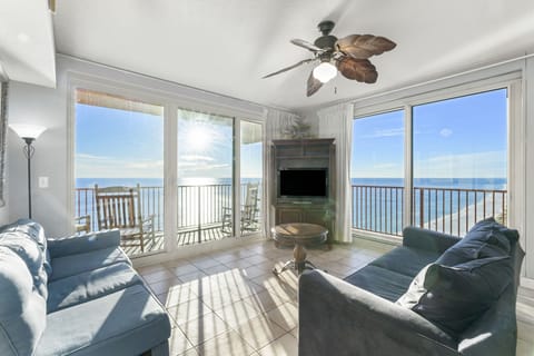 Relax in this bright living room with ocean views and access to a balcony.