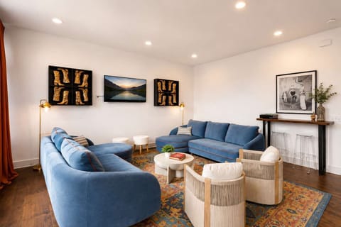 Cozy living room with calming blue accents and comfortable seating for a warm, inviting retreat.