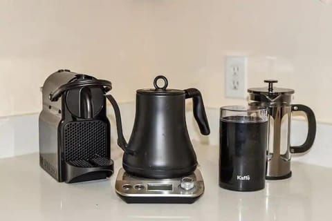 Elevate your coffee experience with a Nespresso machine, coffee grinder, and French press, ensuring a variety of options for your perfect brew.