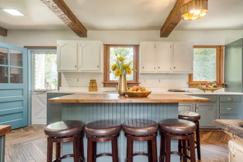 Charming country kitchen with barstools at the island counter.
