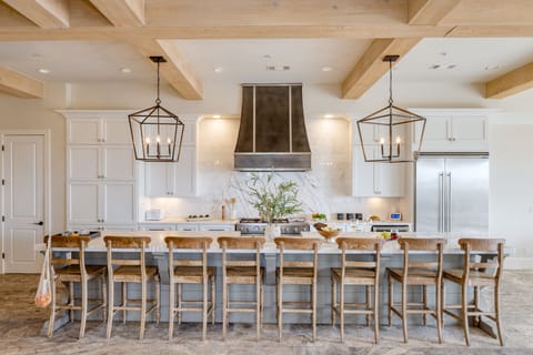 Kitchen features a large island with 8 barstool seats.