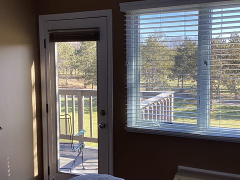 Master bedroom door to large deck overlooking golfcourse