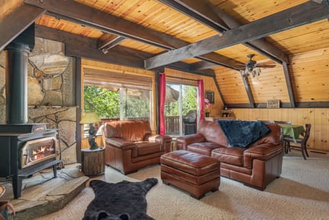 Cozy cabin: wood stove, plush sofas. Gather, relax, connect in inviting space.