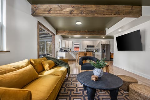 Spacious living room with smart TV and comfortable seating for everyone.