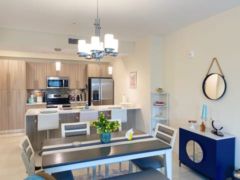 Dining area with a full kitchen in background. 