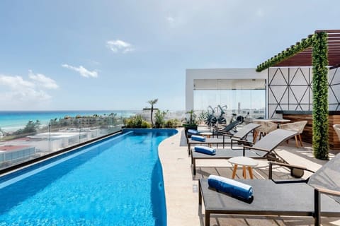 Take a refreshing swim in the stunning rooftop infinity pool with ocean views.