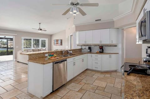 Kitchen Offers an Open Layout to the Living Room with Water Views
