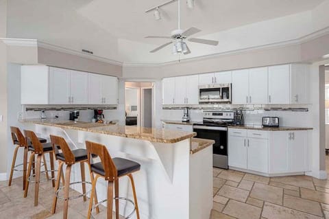 Large Open Kitchen with Bar and Stainless Appliances