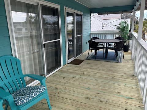 Step into paradise and soak up the warm Florida breeze on this charming front deck, where relaxation and tranquility 