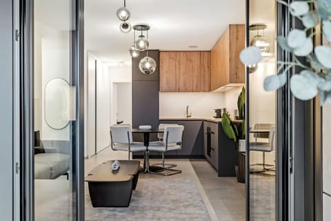 From the balcony, gaze into a living space where natural light and modern amenities blend to create a welcoming urban retreat.