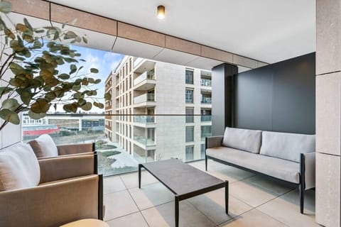 Relax on the balcony with urban views, a perfect spot to unwind and enjoy the pulse of the city from above.
