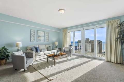 Relax in this bright living room with ocean views through large sliding glass doors.