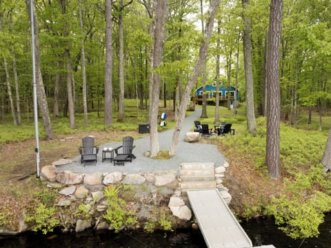 From deck to dock, this sweeping lakefront yard brings it all together - kayaks, firepit, and private lake access included.
