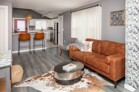 Living room w/comfy leather sofa and two accent chairs for plenty of seating.