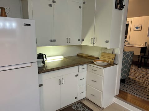 Fully stocked utensils, pots, pans, glasses, dishes and some spices.