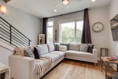 Bright first‑floor living area with comfy seating and TV.