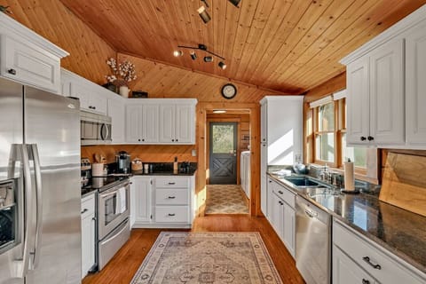 Fully stocked kitchen with stainless steel appliances and everything you`ll need to make a home cooked meal