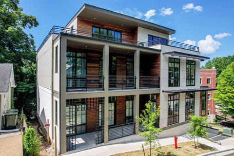Modern architectural multi-level residence featuring expansive private balconies and large windows for natural light.