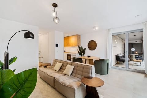 Enjoy your favorite shows in our sleek, well-lit living room with comfortable seating.