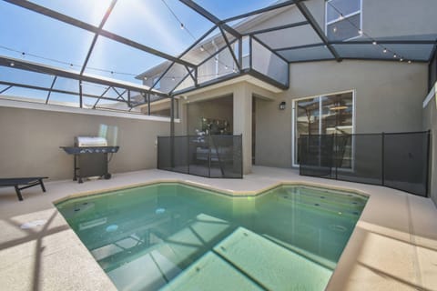 Experience your private retreat with a sparkling pool in a stylish screened enclosure that welcomes sunlight. The convenient outdoor grill area is ideal for casual barbecues, making your stay truly enjoyable.