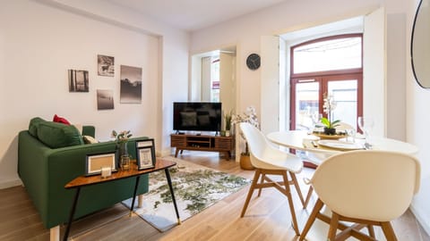 Spacious living area, with a dining area for four people and a seating area with a comfortable couch #sweet #stunning