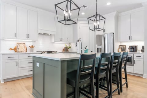 Fully stocked kitchen is open concept with additional island seating