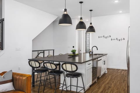 Massive kitchen island with seating for 8. High-end appliances including a wine cooler for a luxe cooking experience.