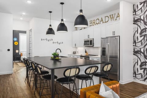 Massive kitchen island with seating for 8. High-end appliances including a wine cooler for a luxe cooking experience.