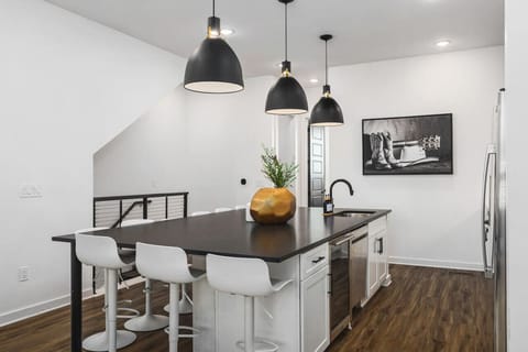Huge kitchen on the main floor of the house with a massive island, seating for 10, and all the appliances / supplies you'd need to cook a meal.