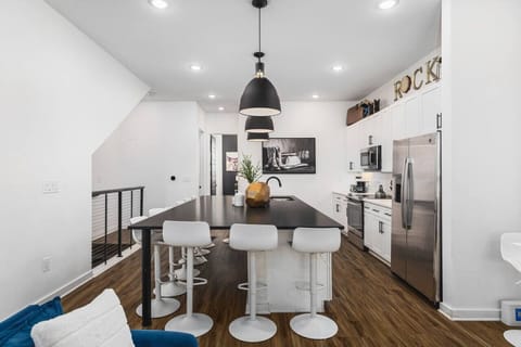 Huge kitchen on the main floor of the house with a massive island, seating for 10, and all the appliances / supplies you'd need to cook a meal.