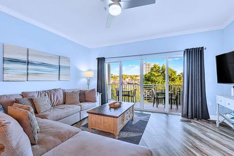 🛋️ Spacious Living Room – Cozy sofa, flat-screen TV, and balcony access