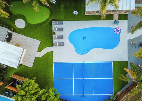 Bird's-eye view of your private backyard oasis - pool, pickleball court, putting green and plenty of room to play