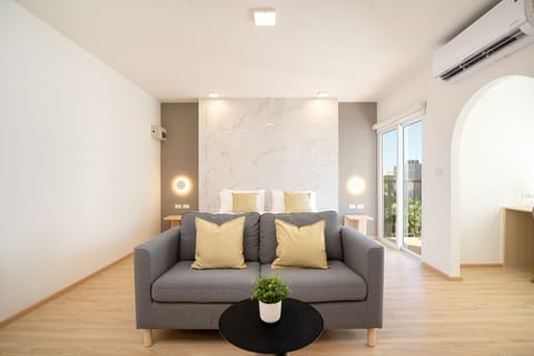 Suite, 1 Bedroom with balcony | Living area | 40-inch Smart TV with digital channels