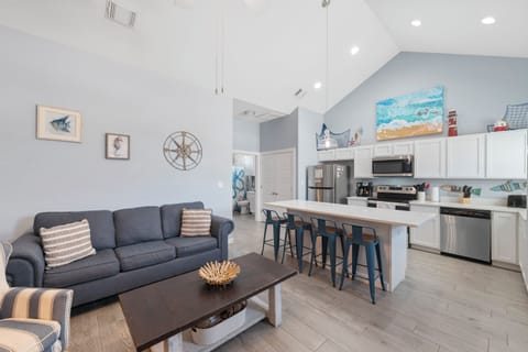 Relax in your bright, open-concept space where coastal charm meets modern comfort. Your kitchen island awaits morning coffee while you plan beach adventures.