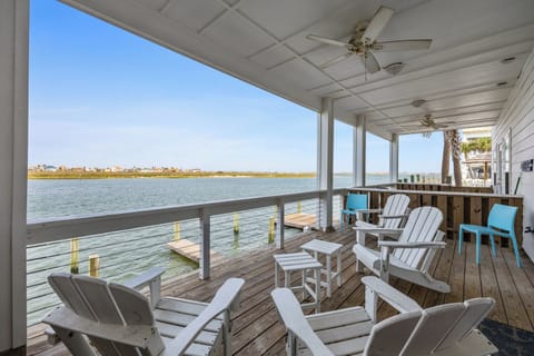 Your private waterfront deck awaits with Adirondack chairs perfect for morning coffee and sunset cocktails over tranquil waters.