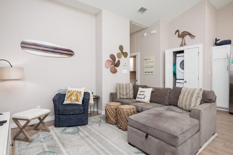Sink into plush gray sectional seating surrounded by coastal charm and nautical touches in your bright, airy living space.