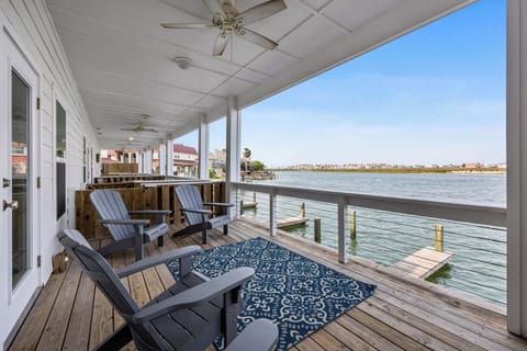 Relax on your private waterfront deck with stunning lake views, comfortable seating, and gentle ceiling fans creating the perfect escape.