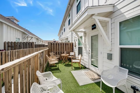Your private outdoor terrace features synthetic turf, modern seating, and dining space - perfect for morning coffee or evening relaxation.