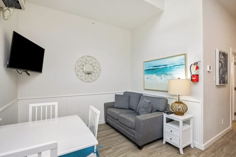 Relax in your bright living space with coastal artwork, comfy seating, and entertainment to make you feel right at home.