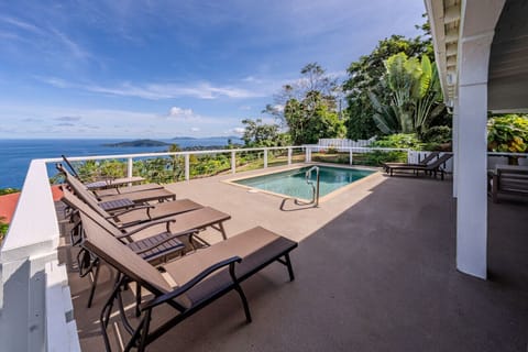 The partially covered pool deck with wifi, outdoor furniture, sun loungers, & BBQ grill - all with an incredible view!
