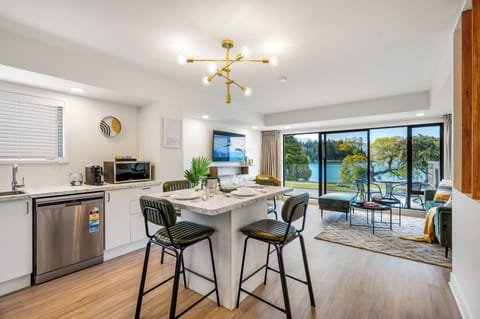 Open plan living, full kitchen, breakfast island with alps and lake views