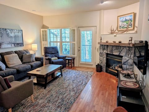 The living room features plenty of seating, a private fireplace, and Smart TV